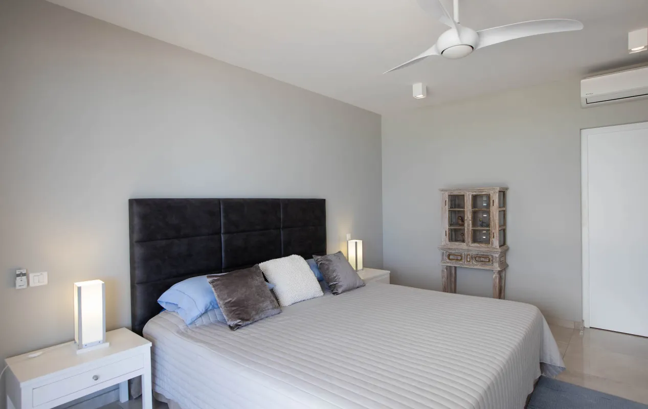 Villa L'Ecume des Jours: Bedroom with a king-size bed, white nightstands, and a ceiling fan