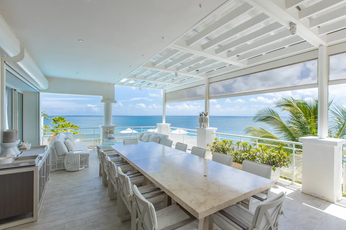 Villa L'Oasis: Covered terrace with a large dining table and lounge seating overlooking the ocean