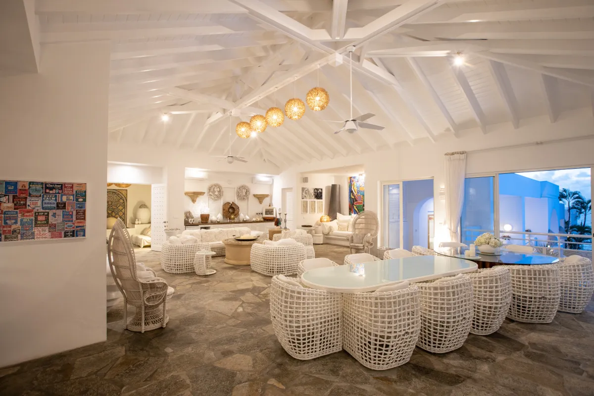 Villa L'Oasis: Spacious open living and dining area with white woven chairs and high vaulted ceilings