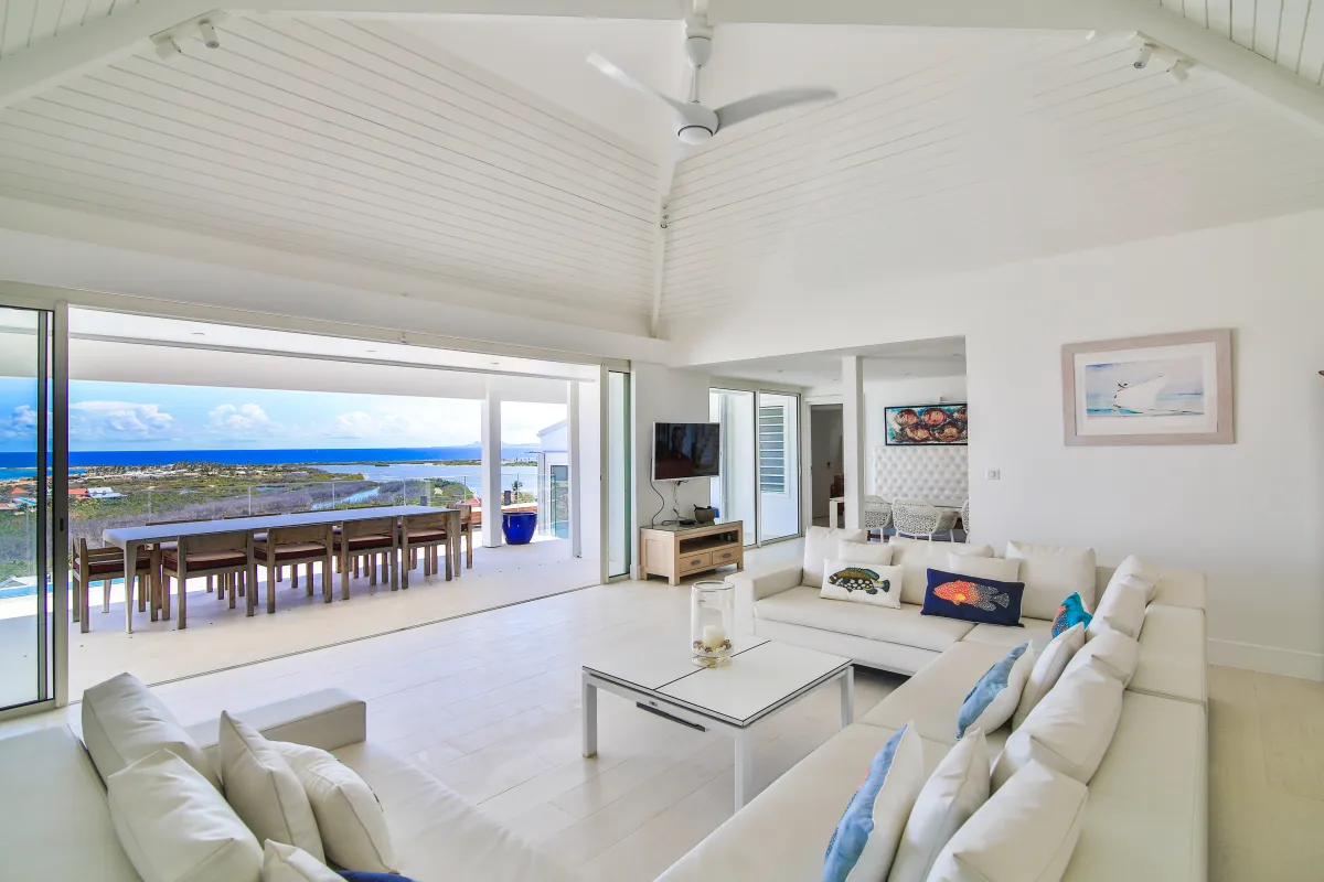 Villa Mango: Spacious white living room opening onto a terrace with ocean views