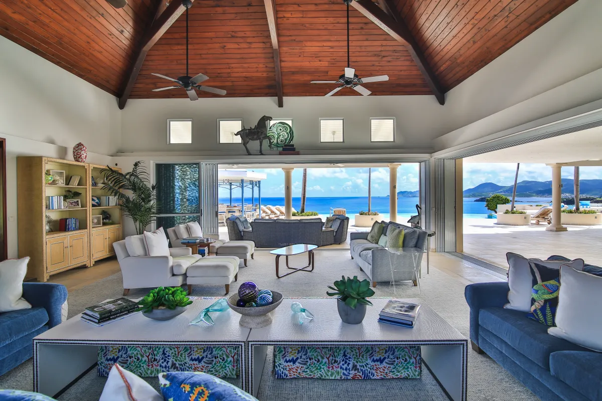 Villa Mes Amis: Spacious living room with vaulted wood ceiling opening to a sunny terrace with sea views