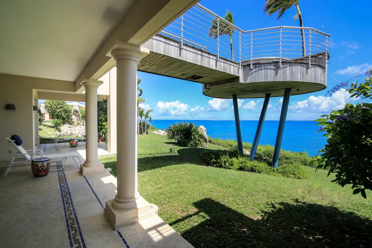 Villa Mes Amis: Covered patio and elevated viewing platform overlooking a lawn and the ocean