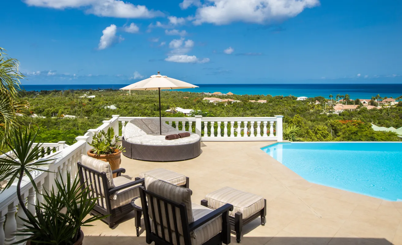 Villa Mille Fleurs: Outdoor terrace with lounge seating, a round daybed, and a pool overlooking the sea