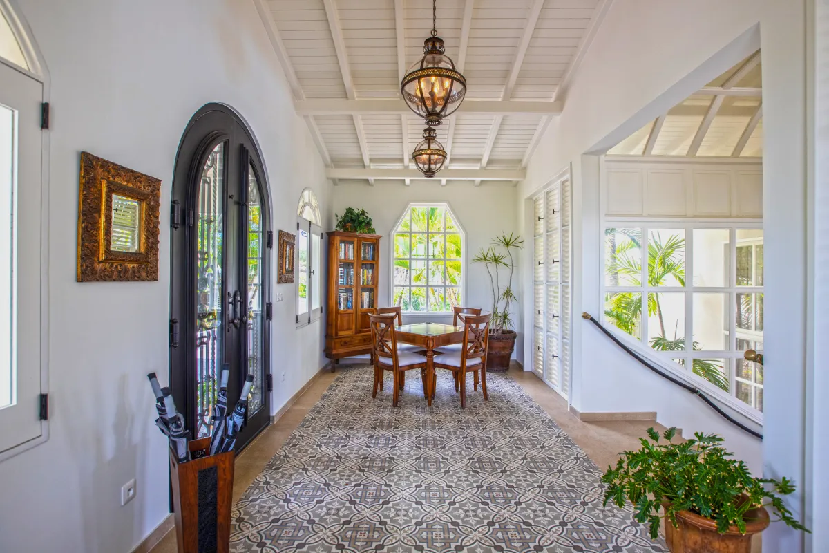 Villa Mille Fleurs: Enclosed gallery with patterned tile floor, dining table, and hanging pendant lanterns