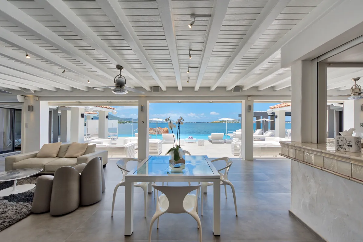 Villa Mirabelle: Open-plan living and dining area opening onto a sunny terrace with ocean views