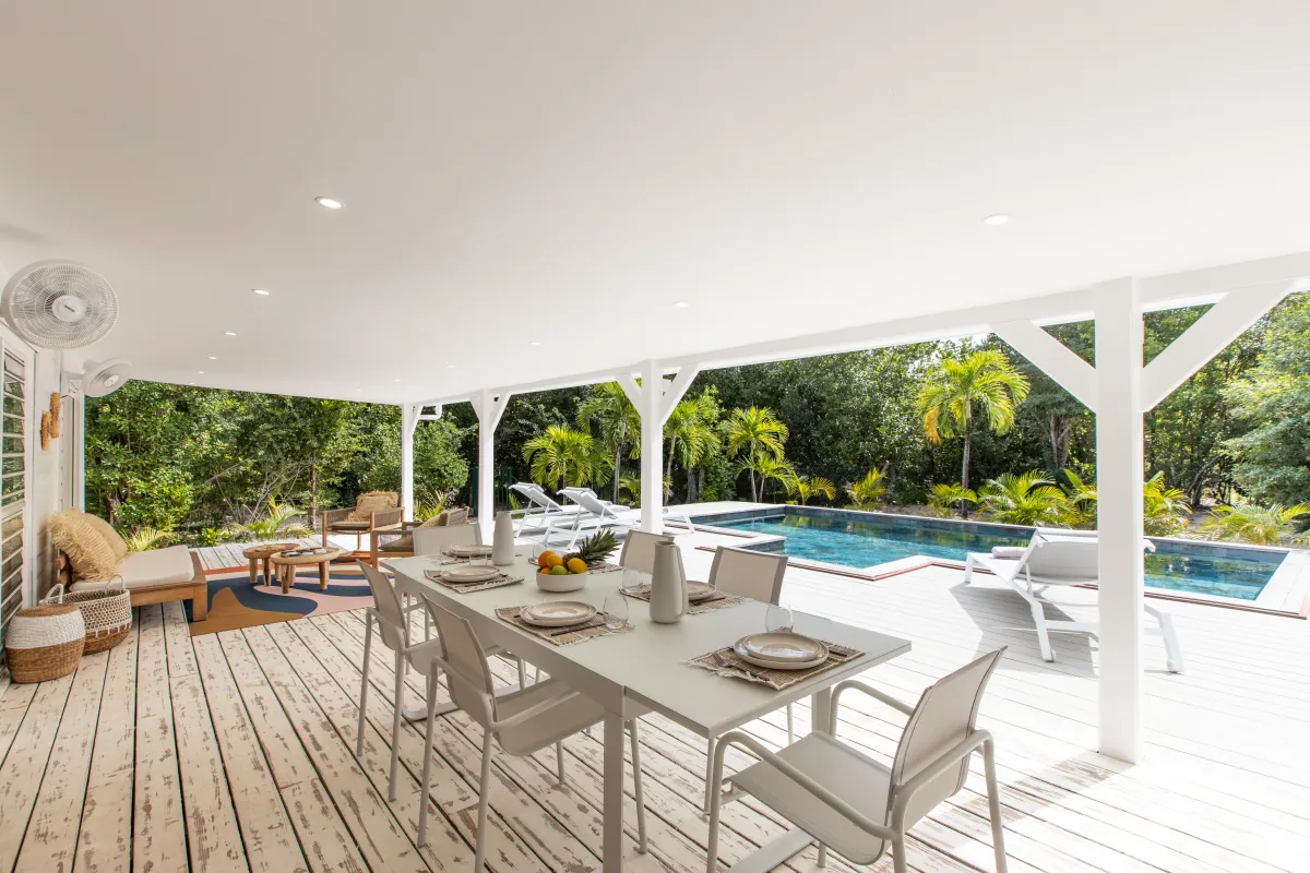 Villa Monchal: Covered terrace with outdoor dining table and lounge seating overlooking the swimming pool