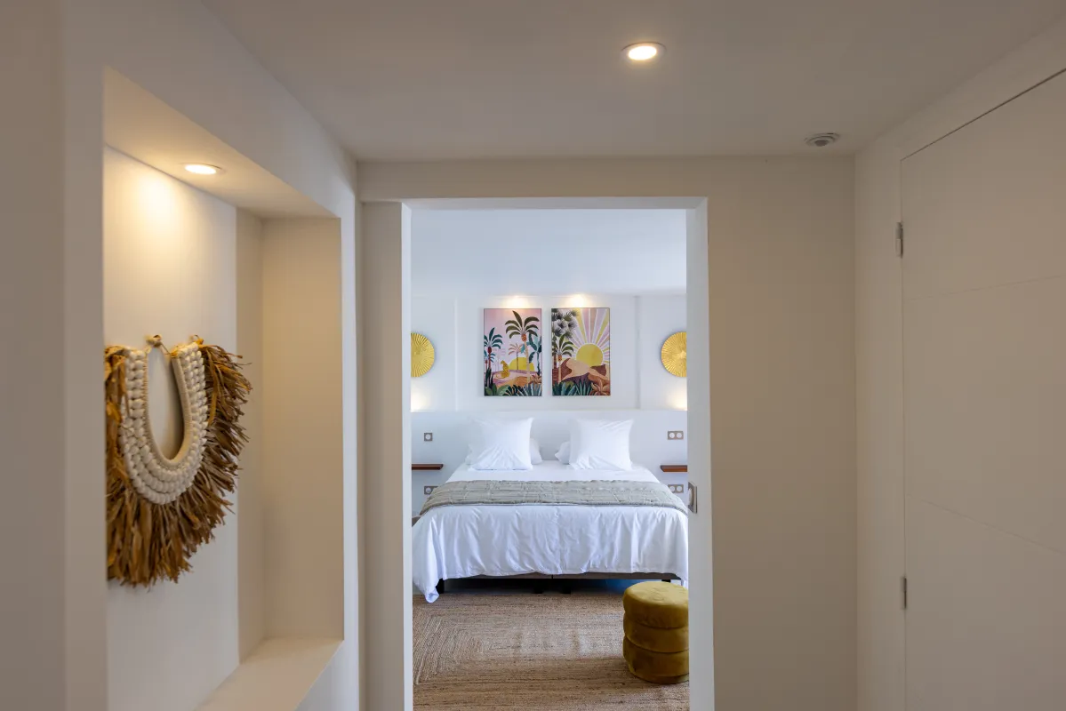 Villa Nuit Jade: View through a doorway into a modern bedroom with artwork above the bed
