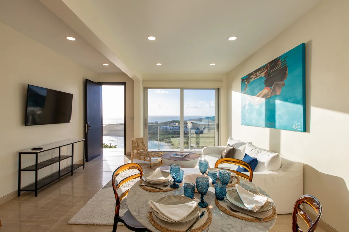 Villa Numa: Open living and dining area with sea views through sliding glass doors