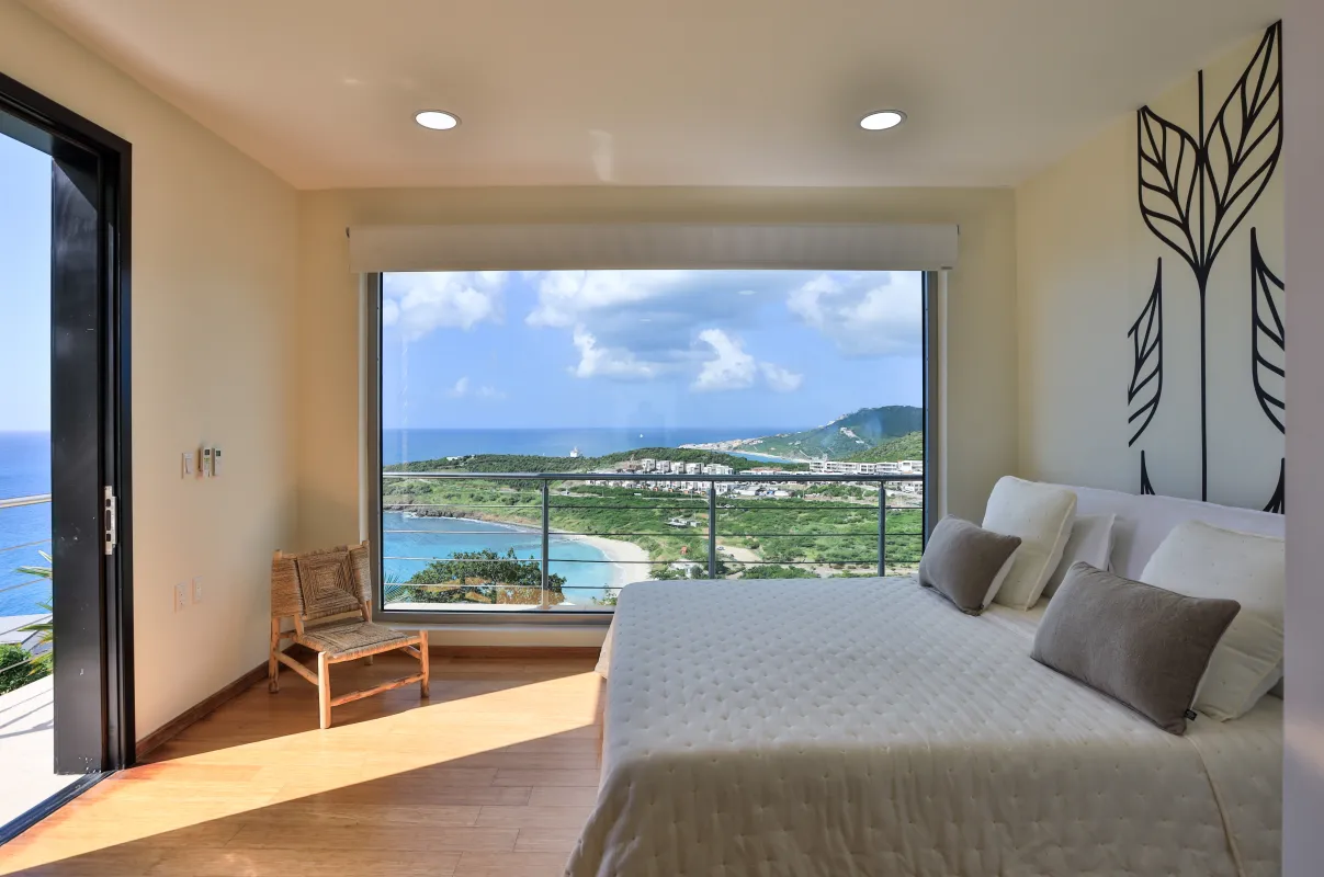 Villa Numa: Bedroom with a large picture window overlooking the ocean and coastline