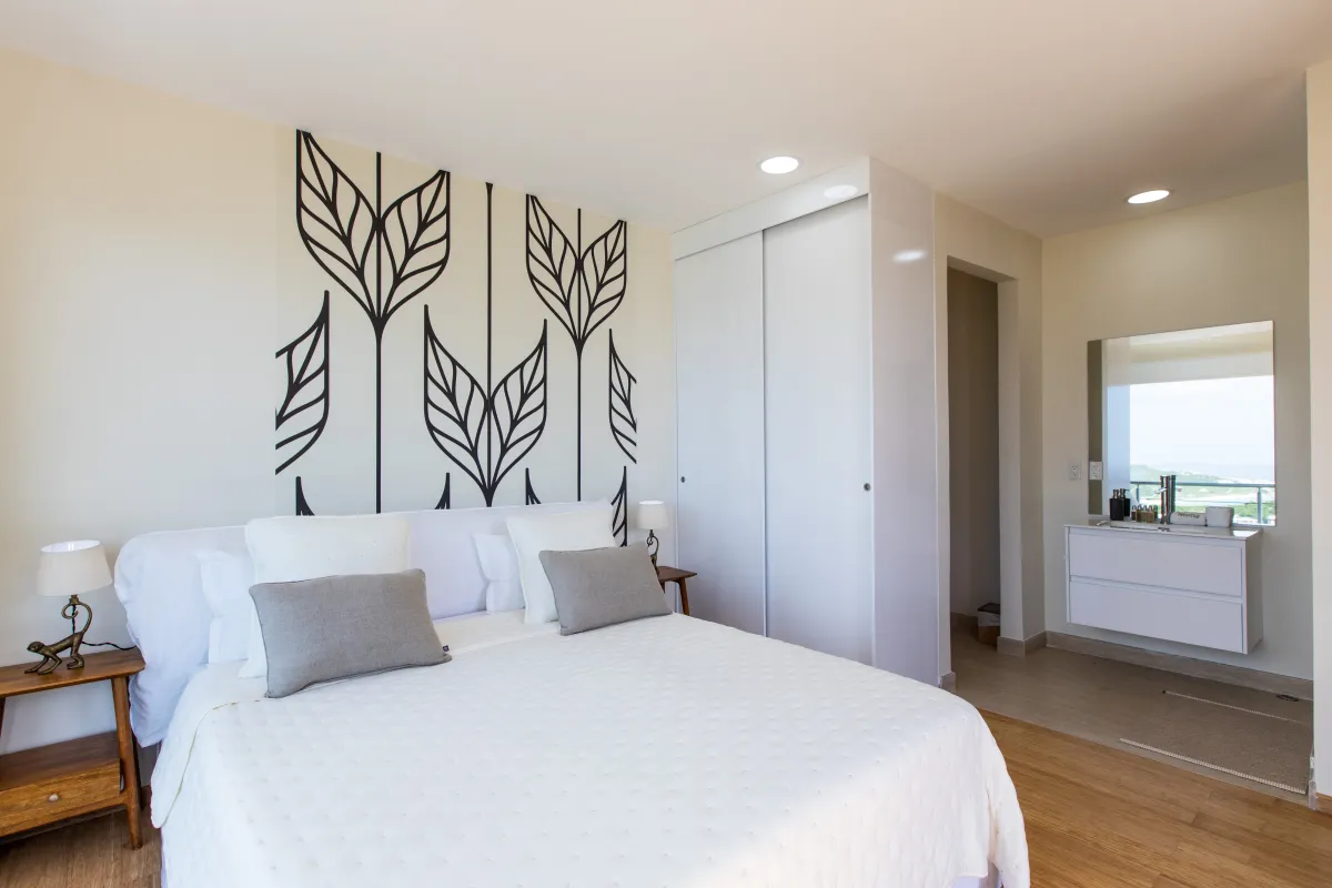 Villa Numa: Bedroom with a king bed, graphic wall art, and an en suite vanity