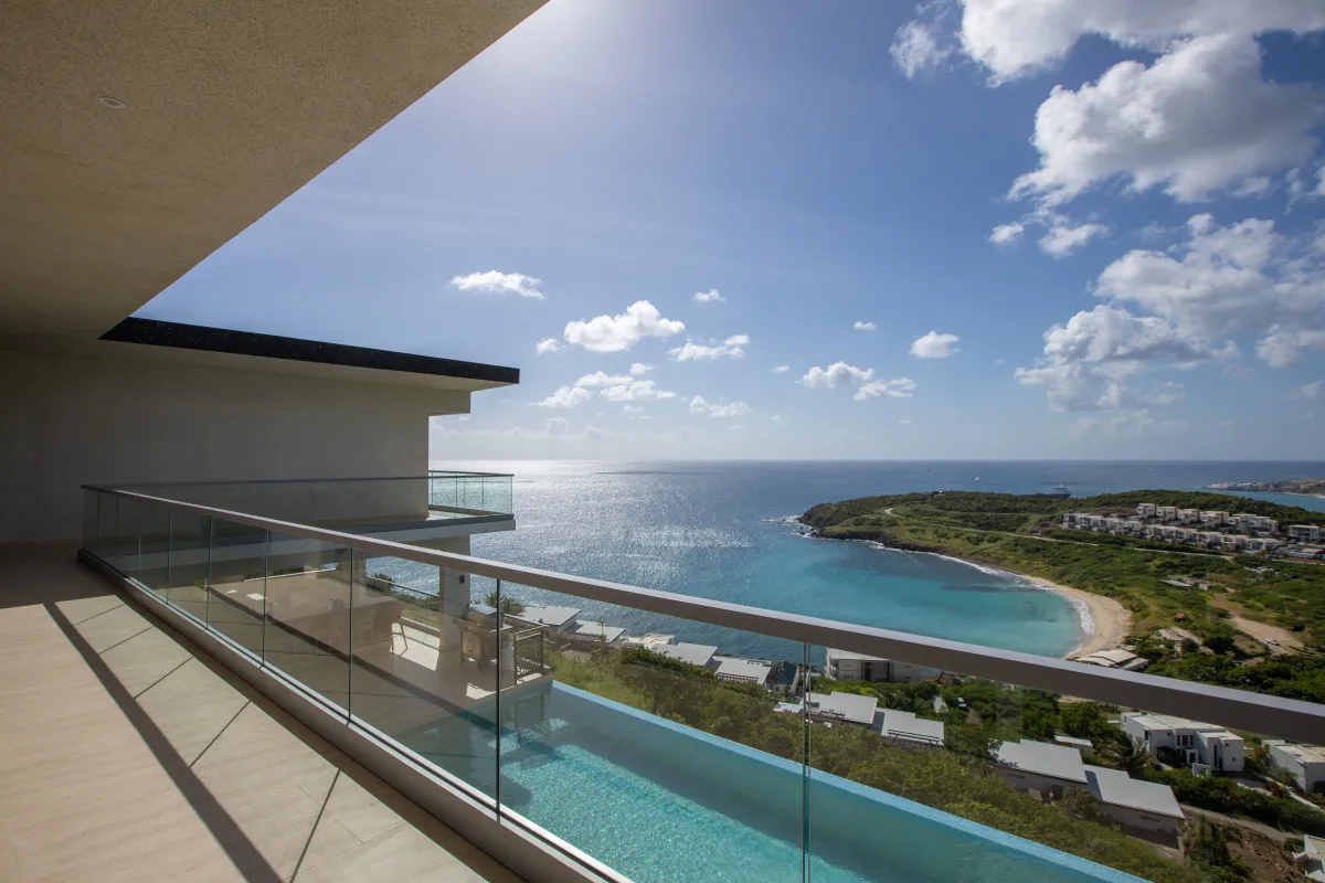 Villa Numa: Balcony overlooking an infinity pool and a coastal bay surrounded by green hills