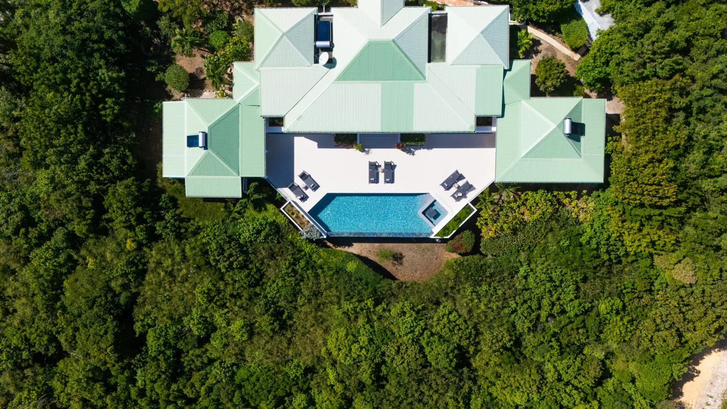 Villa Osun: Aerial top-down view of a villa with green roofs, swimming pool, and dense forest
